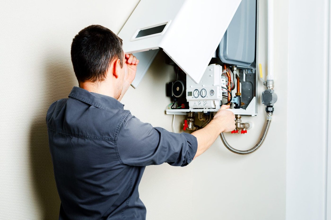 Technician diagnosing boiler with diagnostic software